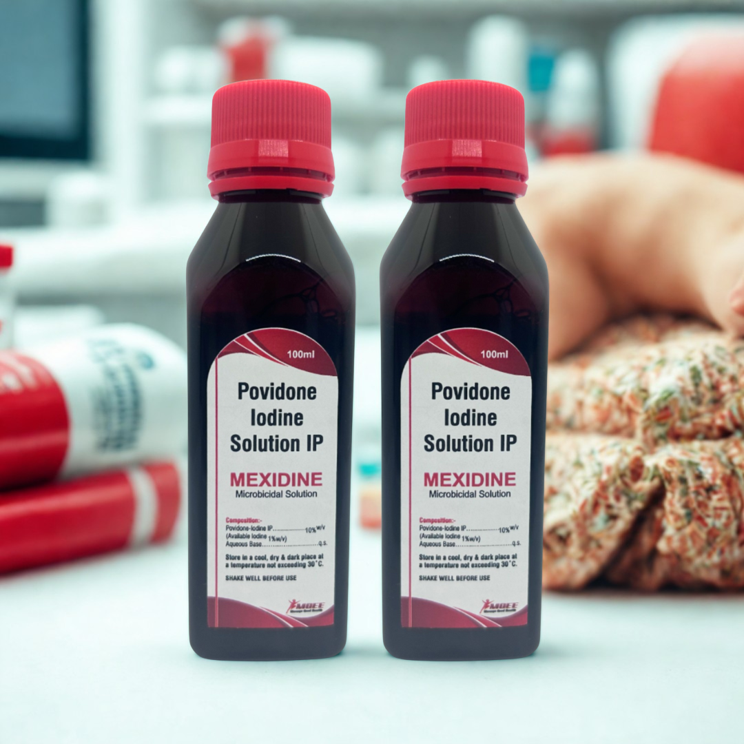 Two bottles of Povidone Iodine Solution IP labeled 'Mexidine' on a blurred background.