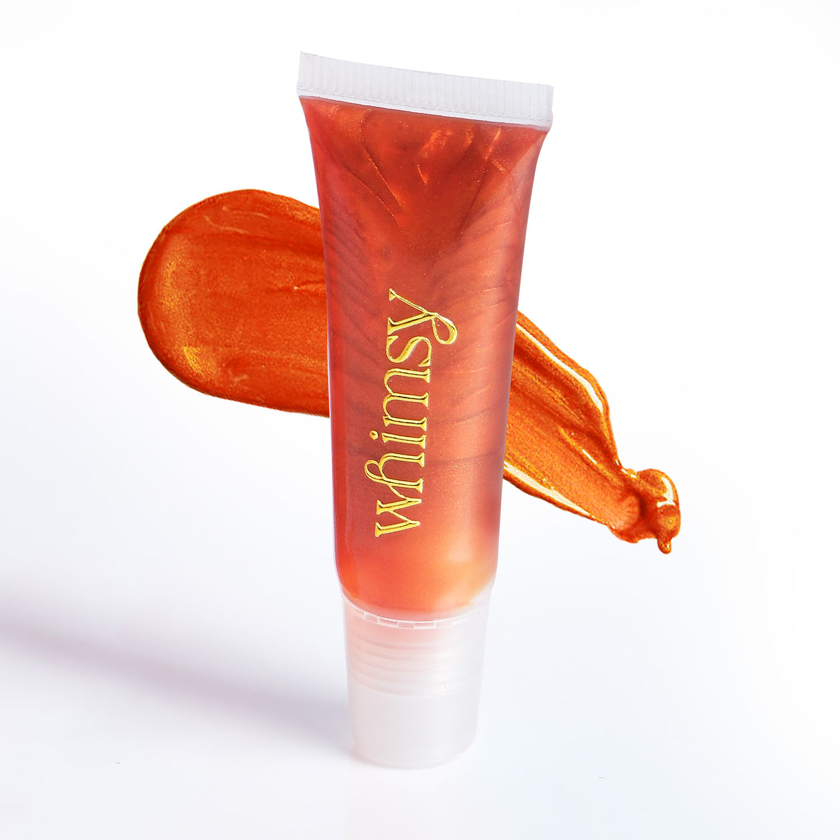 Orange lip balm tube with 'whimsy' branding on a white background
