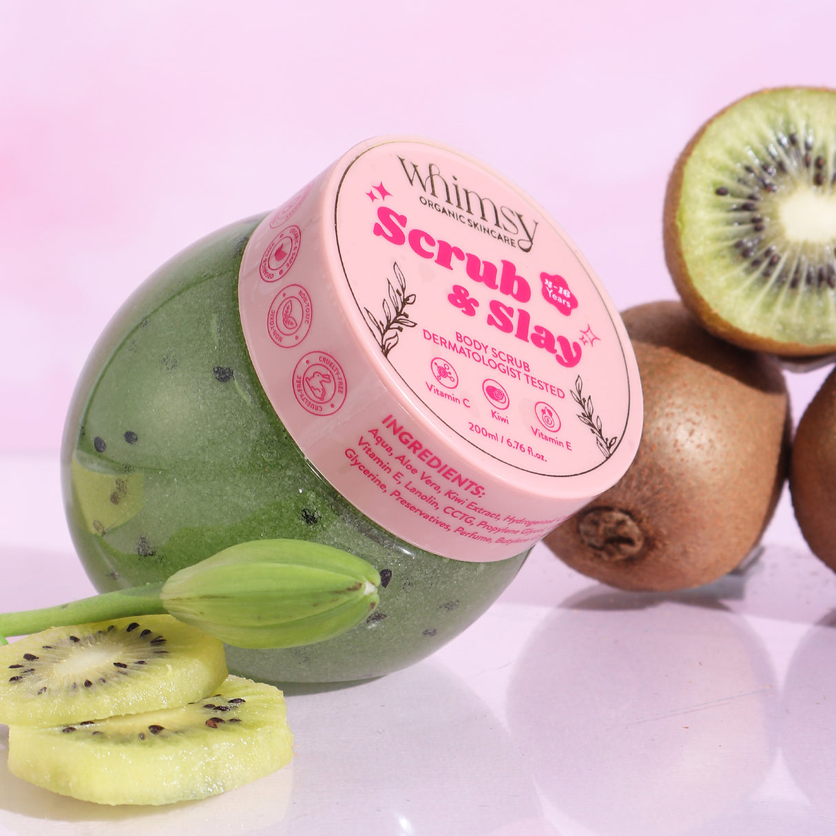 Green kiwi scrub ball with pink label on a pink background