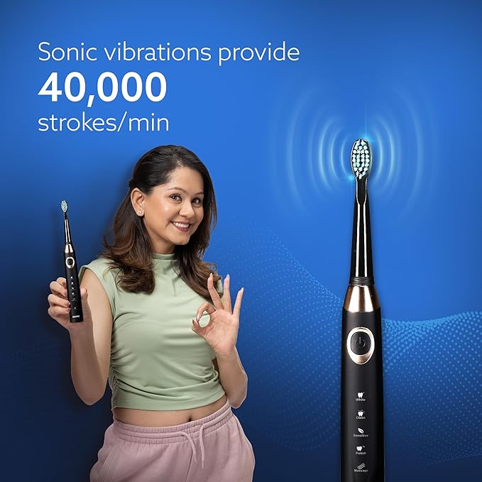 Woman holding a black electric toothbrush
