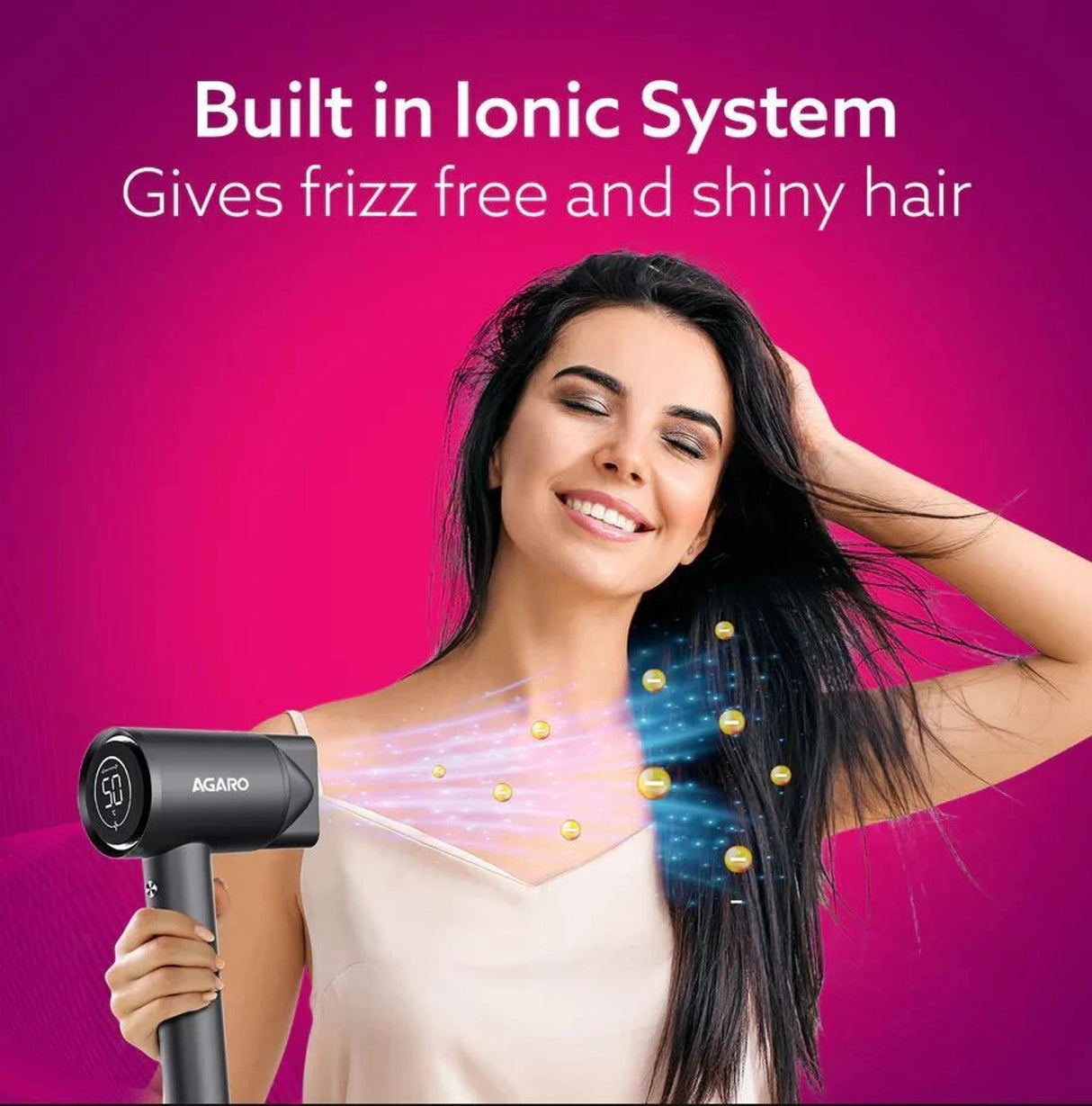 Woman using a hair dryer with ionic technology on a pink background