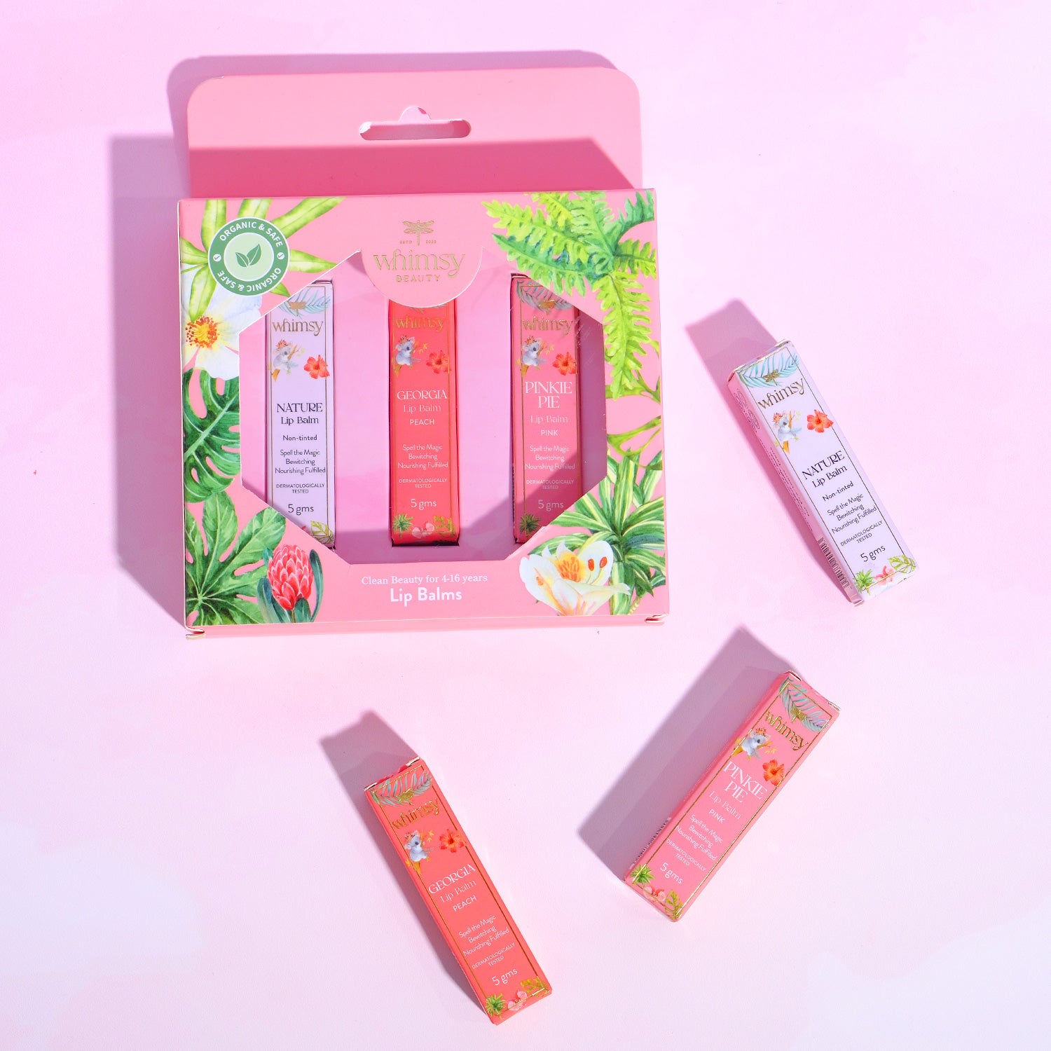 Lush lip balm set with packaging on a pink background