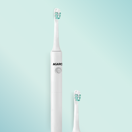 White electric toothbrush with Agaro branding on a light blue background