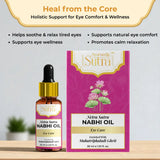 Netra Sutra Nabhi Oil bottle and packaging on a wooden