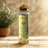 Bottle of Neotive DS oil on a wooden surface with a blurred plant in the background