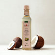 Bottle of Organic Virgin Coconut Oil with coconuts on a light background