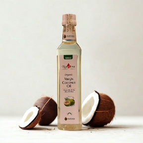 Bottle of Organic Virgin Coconut Oil with coconuts on a light background