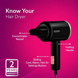 Black hair dryer with features labeled on a pink background