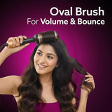 Woman using an oval brush for volume and bounce with a purple background