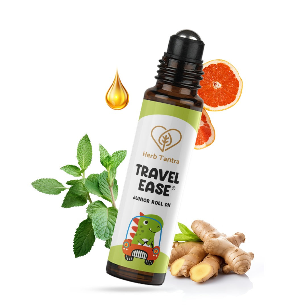 Herb Tantra Travel Ease junior roll on bottle with mint leaves, ginger root, and orange slices on a white background