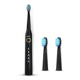 Black electric toothbrush with three brush heads on a white background
