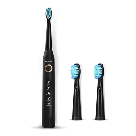 Black electric toothbrush with three brush heads on a white background