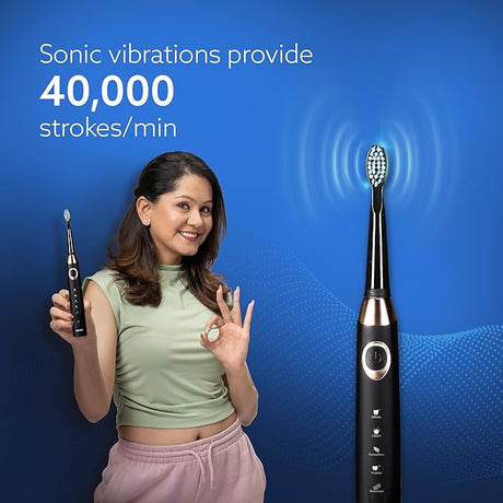 Woman holding a black electric toothbrush