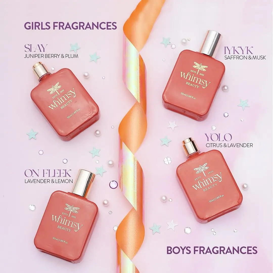 Four perfume bottles from 'The Whimsy' brand on a pink background with product names and scents.