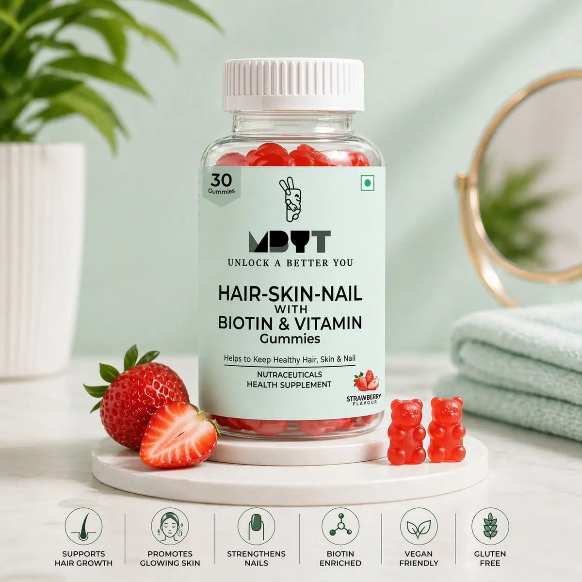 Hair-skin-nail gummies with Biotin and Vitamin C on a white surface with strawberries and a plant in the background.