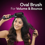 Woman using an oval brush for volume and bounce with a purple background
