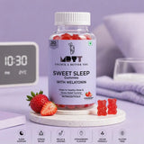 Bottle of MDYT Sweet Sleep Gummies with Melatonin on a table with strawberries and a clock in the background.